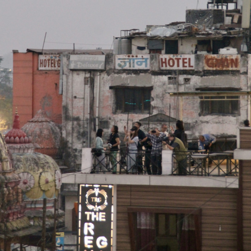 Andere Touristen auf einer Dachterrasse beobachten die Feuerzeremonie.